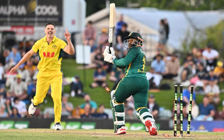 South African batsman bowled out by Australian bowler celebrating